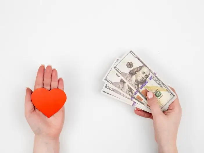 hand-with-paper-heart-gift-box