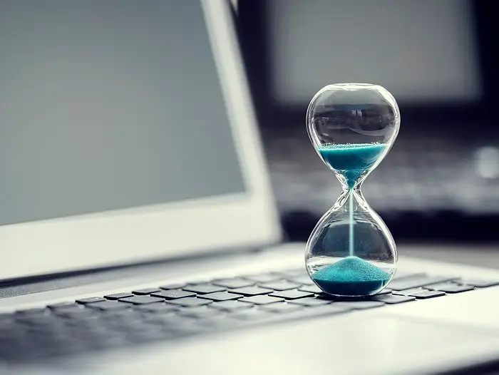 bigstock-Hourglass-on-laptop-compute