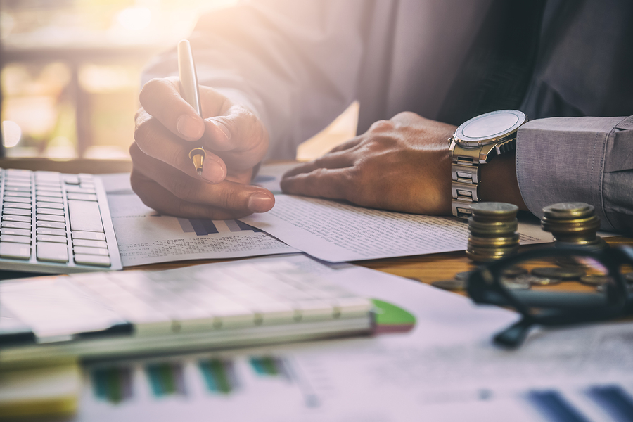 A person doing the church's accounting books using a simple to use software for accounting. A person doing the church's accounting books using a simple to use software for accounting.