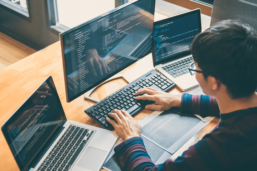 Church software security expert checking the database on multiple monitors. Church software security expert checking the database on multiple monitors.