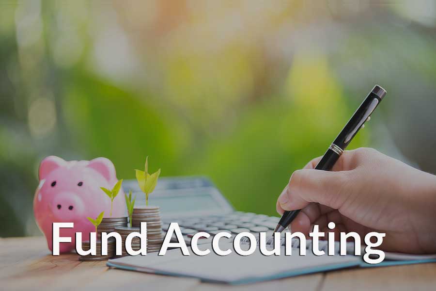 Person doing fund accounting using a calculator and getting ready to put the data into their church management software. Person doing fund accounting using a calculator and getting ready to put the data into their church management software.